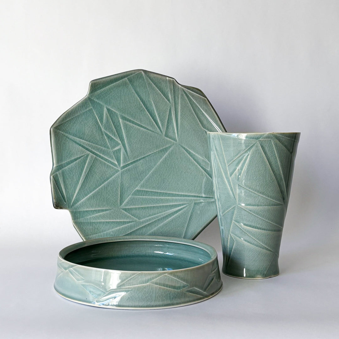 Porcelain High-fire ceramic artwork by Hugh Remar. Example pieces for an intermediate ceramics class focusing on porcelain clay making and decorating methods. 