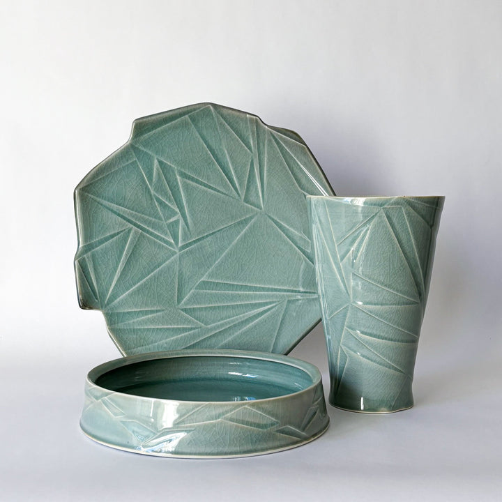 Porcelain High-fire ceramic artwork by Hugh Remar. Example pieces for an intermediate ceramics class focusing on porcelain clay making and decorating methods. 