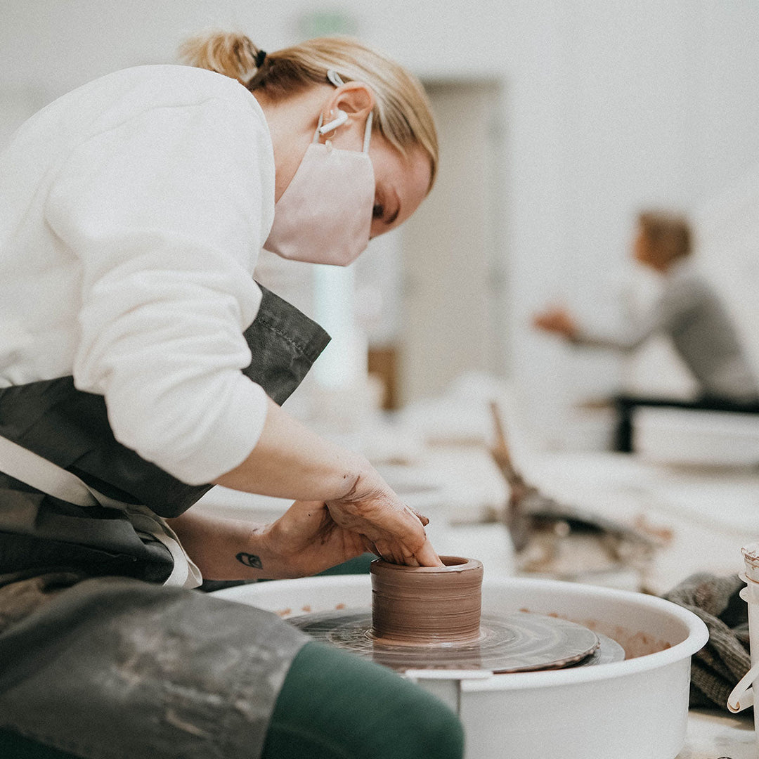 Original Workshops & Classes by Still Life Studio woman throwing a bowl on the potter's wheel
