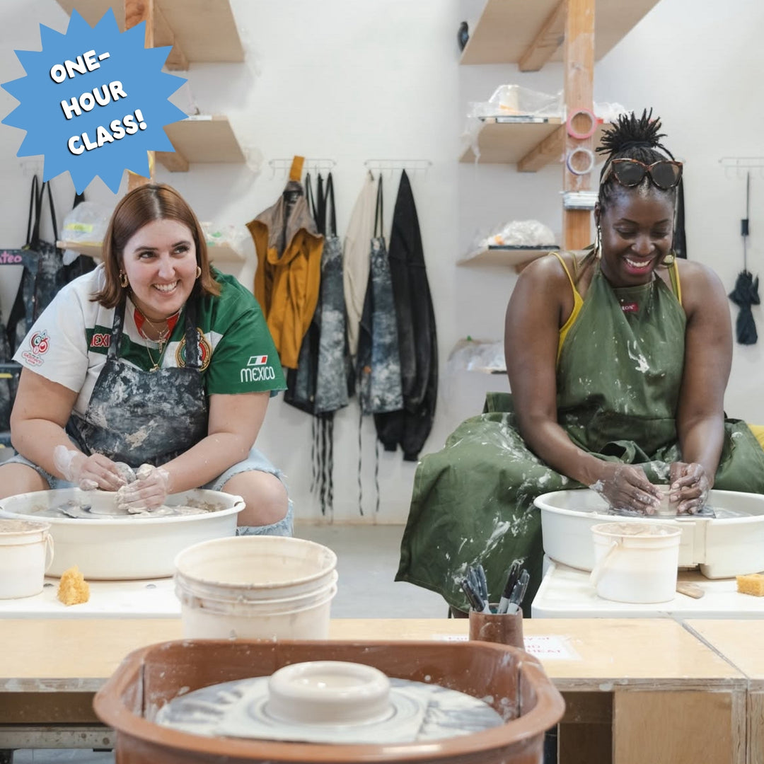 Two women sitting at pottery wheels making bowls in a ceramics class. Text overlay button reads: "one-hour class!"