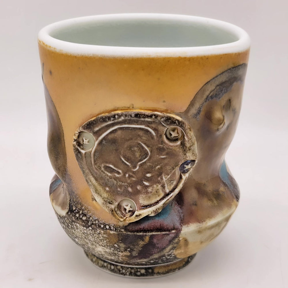 Ceramic cup with artistic design on a white background